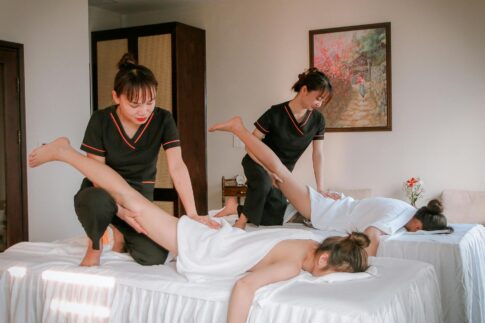 Women receiving therapeutic massages in a serene spa setting, promoting relaxation and wellness.