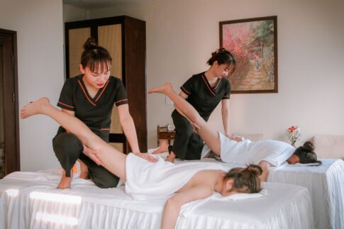 Women receiving therapeutic massages in a serene spa setting, promoting relaxation and wellness.